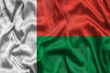 Madagascar national flag background with fabric texture. Flag of Madagascar waving in the wind. 3D illustration.