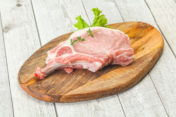 Raw pork bone steak over wooden