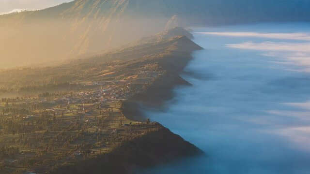 Beautiful Cliff Side Village Sunlight and Misty, Landmark Travel Place of East Java, Indonesia (zoom out)