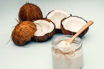 Parts of coconut on a colored background. Close up. Fresh ripe coconut broken into pieces. Coconut oil.