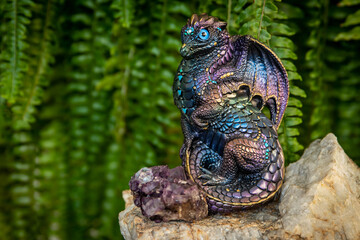 dragon on rock with amethyst and ferns in background