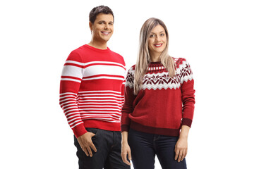 Couple wearing christmas red sweaters and posing