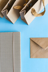 Zero waste concept, kraft brown paper bags and envelope on blue background. 