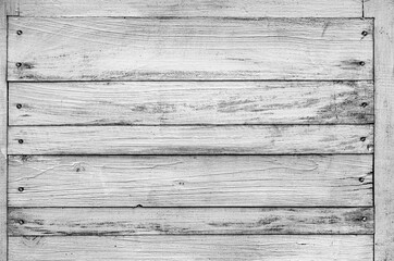 Wooden shield made of several horizontal boards in black and white. Place for text, rustic background