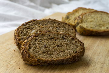 Bread slices on a wooden table. Integral brads. Corn bread. Selective focus. Detail view.