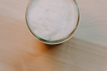 Coffee. White foamy coffee on a natural pine table. Breakfast.