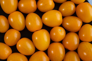 Tasty and healthy yellow ripe tomatoes on a plate