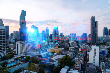 Glowing hologram of Earth planet map on aerial panoramic cityscape of Bangkok at sunset, Asia. The concept of international business. Multi Exposure.