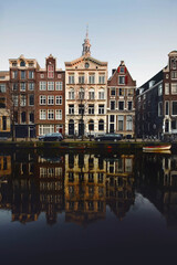Dutch architecture reflected on the canals, the characteristic houses of Amsterdam, the most touristic city of the netherlands