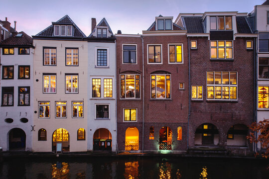 Foreshortening of the beautiful historical center of Utrecht City by night, with the characteristic houses illuminated view from a bridge crossing the dutch canals. Netherlands,Holland, Europe.