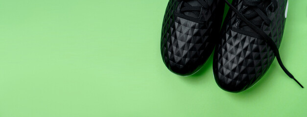 Football boots shoes isolated on green background. Football theme background. long banner.