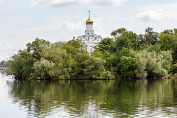 Church of St. Nicholas on Monastery Island in the trees on the bank of the river. Dnipro