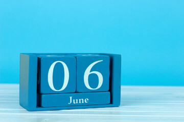 wooden calendar with the date of June 6 on a blue wooden background, World Verneil Disease Day