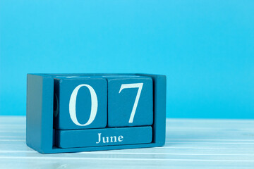 wooden calendar with the date of June 7 on a blue wooden background, International Cancer Survivors Day, World Food Security Day 