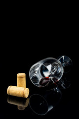 red wine in a glass on a high leg on a black background