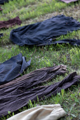 A group of colorful clothes are ayed on the grass.