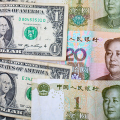 Currencies of major world economies United States and China: US Dollars and Chinese Yuan banknotes.