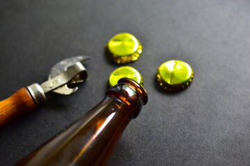 Empty beer bottle opener and gold bottle caps