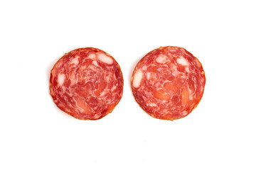 Two slices of raw smoked sausage perfect for pizza topping are on white isolated background