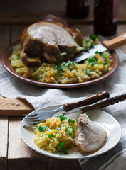 Baked pork knuckle served with stewed cabbage and beer. Rustic style.