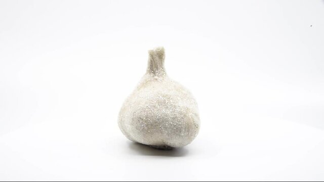 Glitter garlic spinning with a white background. 