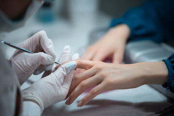 closeup shot and manicure artist making nail cleaning and polishing