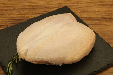 Raw whole chicken breast with skin
