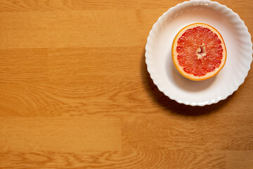 Top view of dried grapefruit cut in half, placed in white saucer
