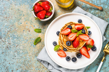Pancakes with fresh berries and honey.