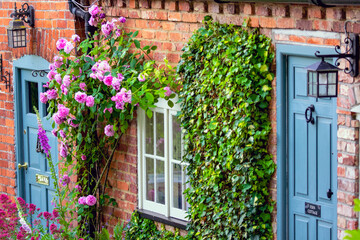 Fototapeta na wymiar Colorful Front Doors windows flowers English house