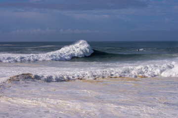 view of the beach with huge waves in Nazare
