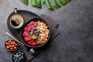 Healthy breakfast with granola, nuts and berries