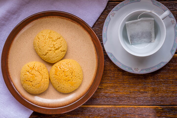 Corn bread on the wooden table with tea and suggar