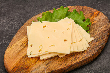 Sliced yellow cheese over board