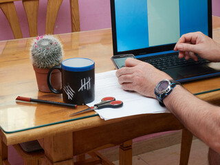 man telecommuting from home using his personal computer