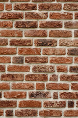 Vertical texture photo of a beautiful decorative brick wall, house facade. Place for text