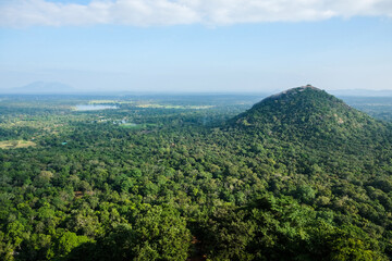 Fototapeta na wymiar Scenic view at Pidurangala Rock hill from the top of Lion Rock Fortress. Hiking in Sri Lanka: beautiful viewpoint at the famous historical site Sigiriya Rock.