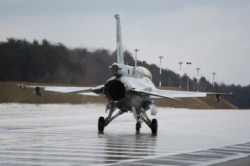 f16 fighter jet from behind on the wet ground in poland during presentation