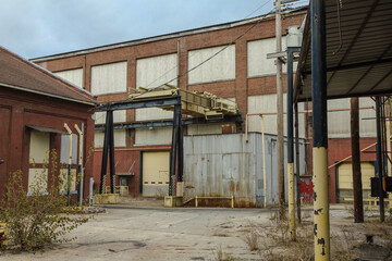 Fototapeta na wymiar Large abandoned industrial warehouse left forgotten in rural Atlanta Georgia