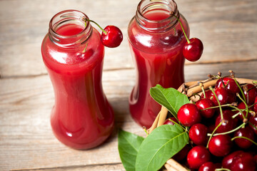 fresh homemade cherry juice in a glass on a wooden table