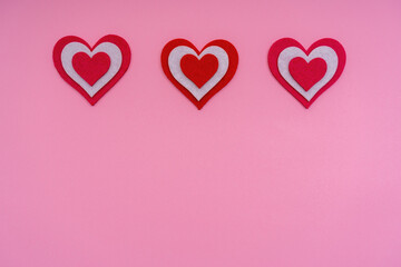 Horizontal red hearts on a pink background. Conceptual photo. Copy space.