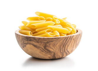 Uncooked penne pasta in bowl. Dried italian pasta