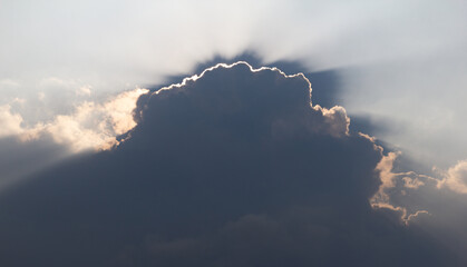 Surreal sun rays are striking through the clouds