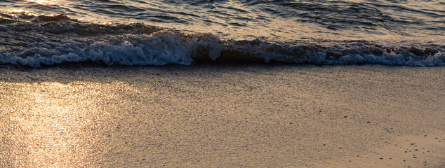 Gentle surf closeup on the Baltic Sea in the sunset