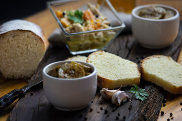 Fototapeta na wymiar minced pickles on wooden board and homemade bread cut into slices, food still life for minced with homemade food