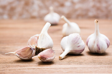 Garlic bulbs whole and lobed on a wooden table. Alternative medicine and folk remedies