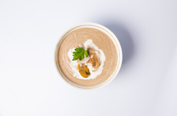 mushroom soup in a white bowl on a gray background