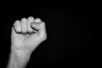 Fototapeta premium Fist isolated on black background. Political movement minorities. Human rights demonstration. Revolution USA. Police brutality stop. Copy space