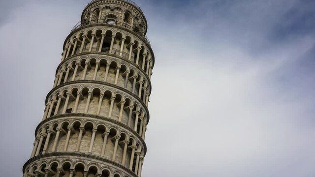Time-lapse of leaning tower of Pisa (Torre di Pisa, piazza dei miracoli). Cloudsing over blue sky, tilt movement camera