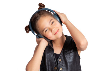 A teenage girl in headphones. A beautiful blue-eyed European girl of 10 years old is listening to...